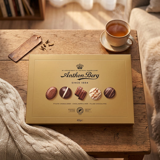 Gold Anthon Berg chocolate box with tea and cozy sweater