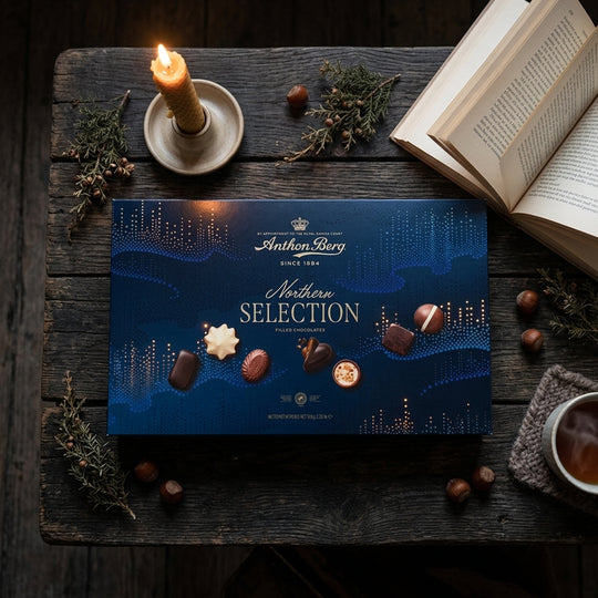 Anthon Berg Northern Selection dark blue chocolate box with gold text on rustic wood