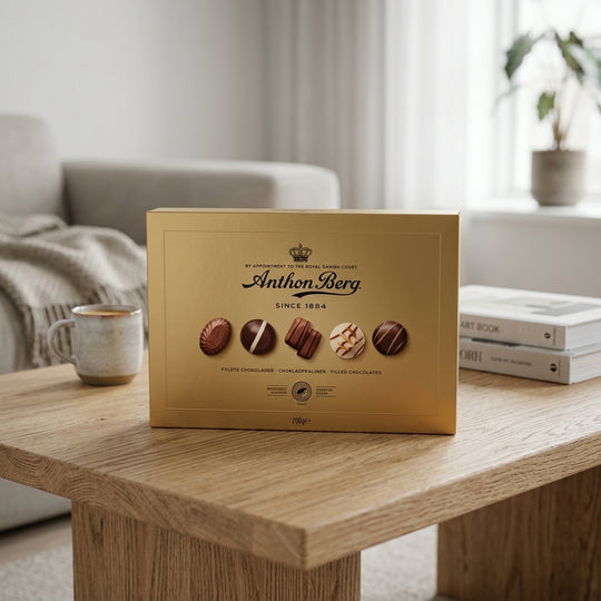 Anthon Berg Guld Ask gold chocolate box with pralines on wooden table