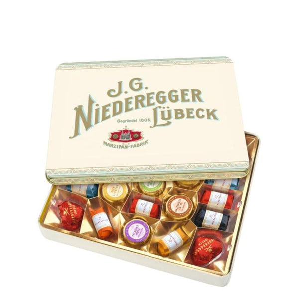 Öppen metallask med Niederegger marsipan, choklad och likörkonfektyr