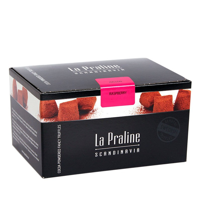 Chokladshopen La Praline hallontryfflar i en elegant svart presentask med rosa etikett.