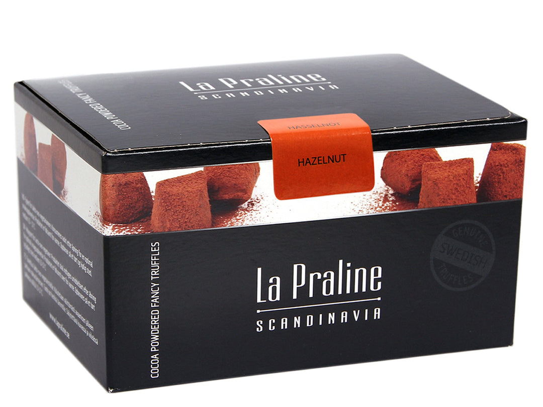 Chokladshopen La Praline hasselnötstryfflar i en elegant svart presentask pudrade med kakao